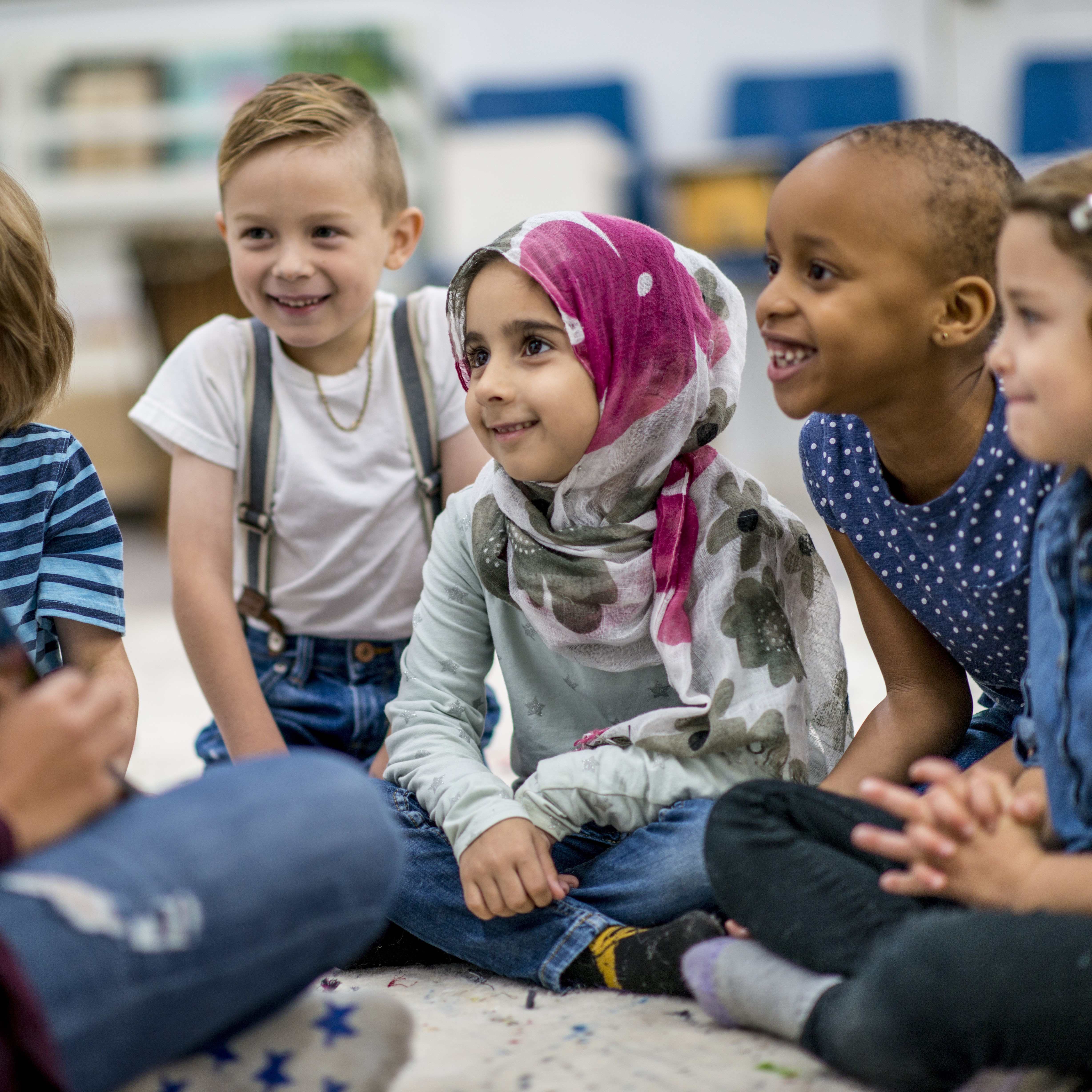 a group of young children sitting on the floor