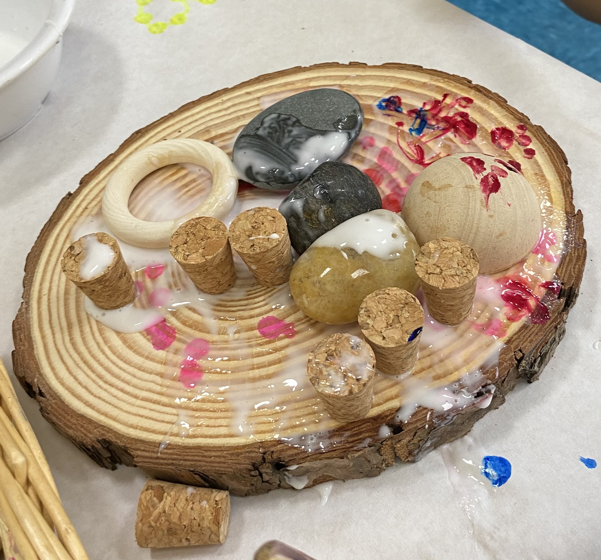 Children use wood as a canvas for displaying their artwork.