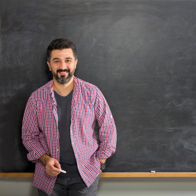 Professional Preparation Standards Man with chalk standing in front of chalkboard