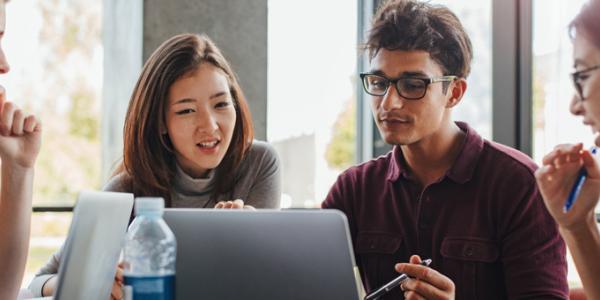 Benefits of NAEYC Higher Education Accreditation Adult students looking at a computer screen together