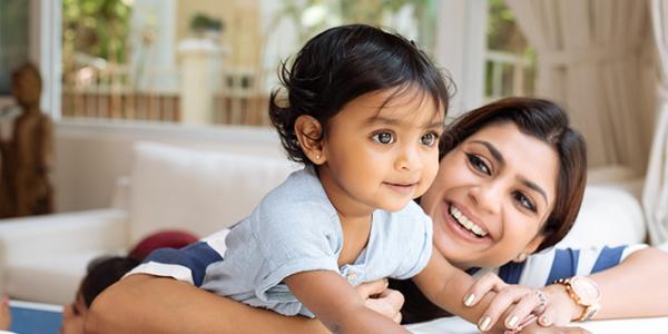 Toddler and mother smiling