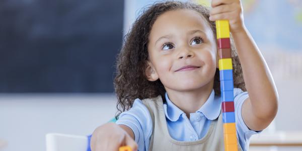 a young girl playing with blocks