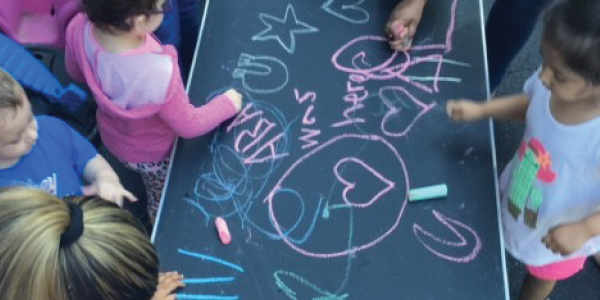 children making a drawing out of chalk