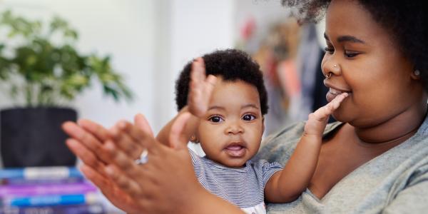 Teacher and infant clapping