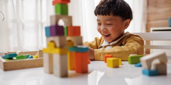 a child playing with blocks on a table