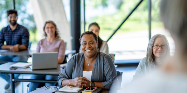 a group of professionals learning in a class setting