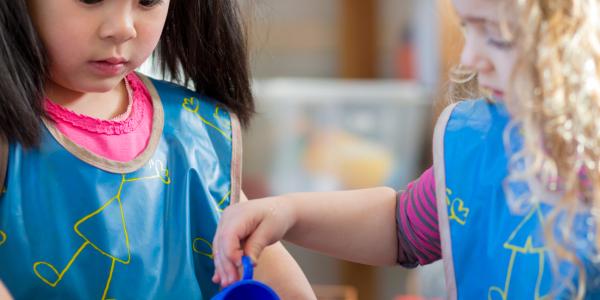 Two children at the water table