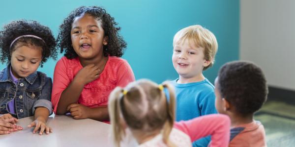 Children talking around a table