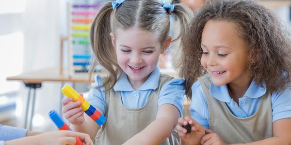 Children building with colored cubes. Children building with colored cubes.