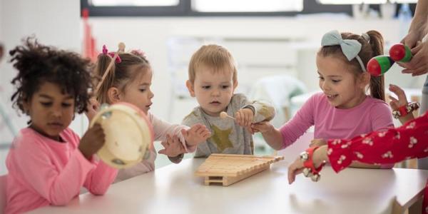 children playing with instruments in a classroom