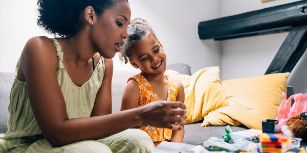 a parent exploring different toys and materials with their child