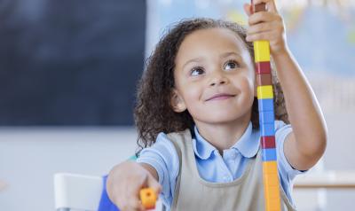 a young girl playing with blocks