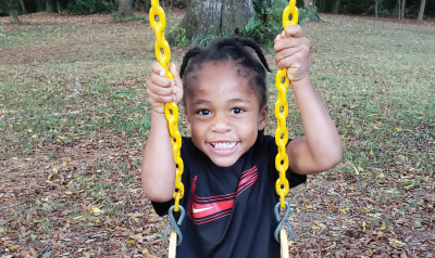 a young child on a swingset