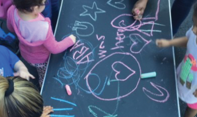 children making a drawing out of chalk