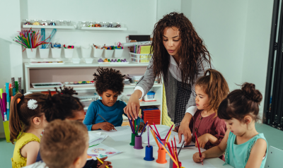 a teacher guiding a child through a project