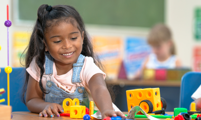 a child playing with toys on a table