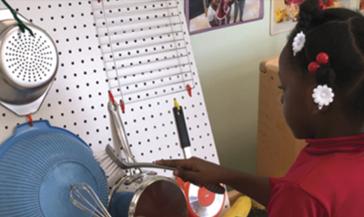 a child sorting items on a peg board