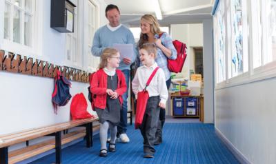 Family walking down school hallway.