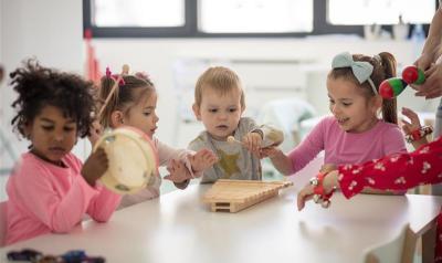 children playing with instruments in a classroom