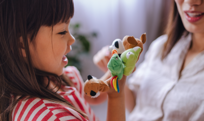 a child playing with finger puppets