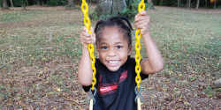 a young child on a swingset