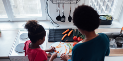 a parent and child cooking together