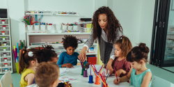 a teacher guiding a child through a project