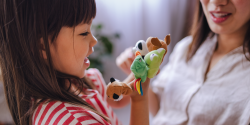 a child playing with finger puppets